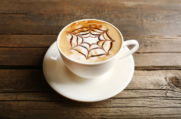 Cup of latte art coffee on wooden background