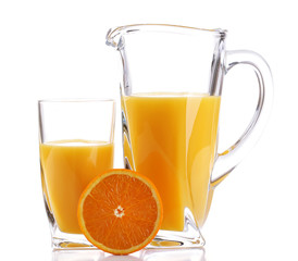 Glass and pitcher of orange juice isolated on white