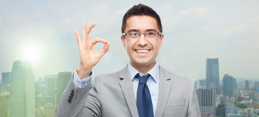 happy smiling businessman in eyeglasses and suit