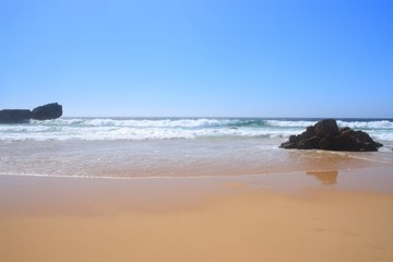 Ocean waves on sandy beach