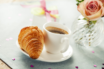 Romantic breakfast with coffee and croissant