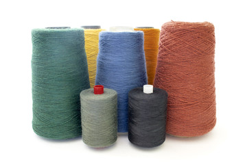 a lot of multicolored yarn and thread isolated over white