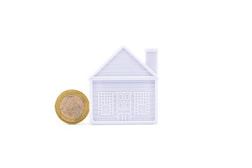 euro coin next to the house on a white background