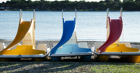 Colorful pedalos on a sea beach in the summer