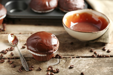 Tasty homemade chocolate muffins on wooden table