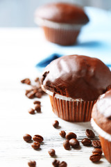 Tasty homemade chocolate muffins on wooden table