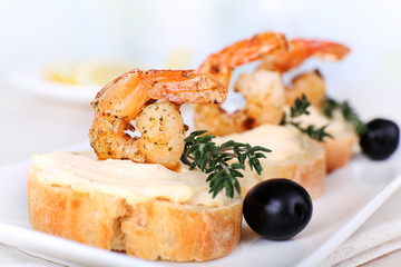 Appetizer canape with shrimp and olives