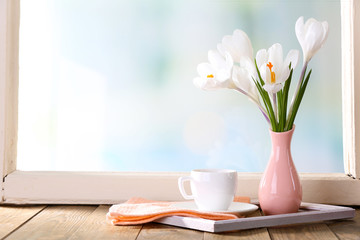 White crocus in vase on windowsill background