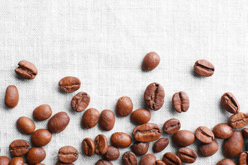 Coffee beans on sackcloth background