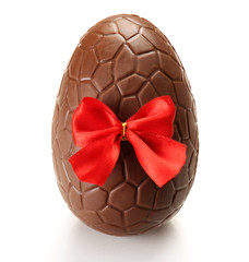 Chocolate Easter egg with color ribbon bow isolated on white
