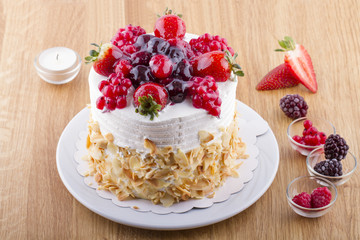 Whole White Berry Fruit Cake on Wooden Table