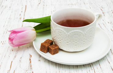 Cup of tea and pink tulip
