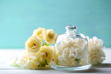 Beautiful composition with flowers on turquoise background