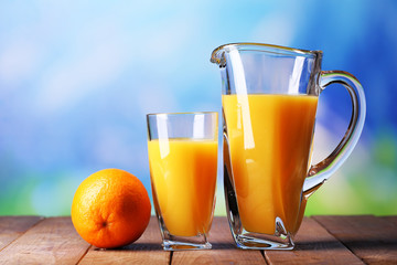 Glass and pitcher of orange juice