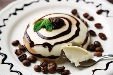 Tasty panna cotta dessert on plate, close up