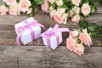 Beautiful pink roses and gift in a white box