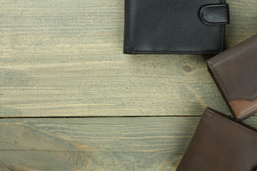 three male purse on wood background