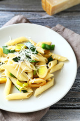 Penne with cheese and onions on a plate