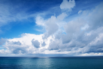 Fototapeta na wymiar blue sea and white clouds in the sky in a calm spring day
