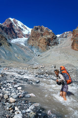 Young girl crossing mountain river