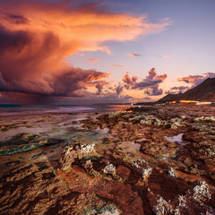 Obraz na płótnie Canvas sunset at coast of the sea with stones