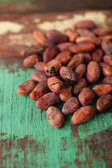 roasted cocoa chocolate beans on wood background