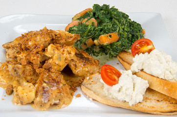 Chicken with sauce and garnish.