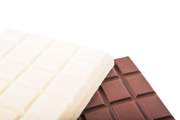 White and dark brown chocolate bars over white background