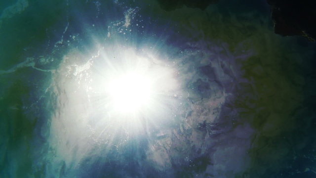 Underwater camera background: sun rays visible from the bottom