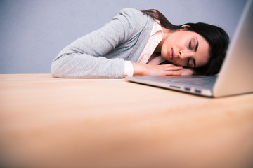 Young pretty woman sleeping on the table