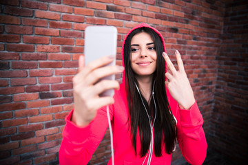 Smiling sportive portive woman making selfie photo