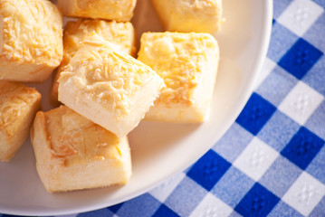 Cheese scones close up on blue checkered tablecloth