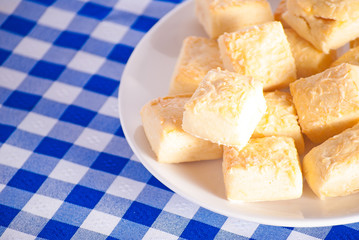 Cheese scones close up on blue checkered tablecloth