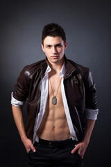 Healthy muscular young man on grey background