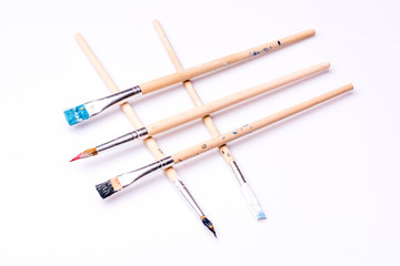 Close up of paint brushes on white background