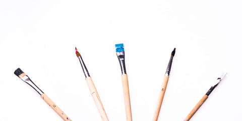 Close up of paint brushes on white background