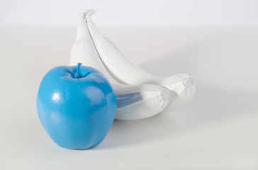 Blue apple and two white bananas.