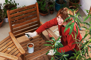 Sanding and painting an outdoor bench