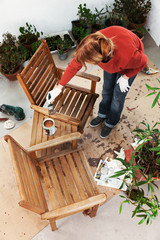 Sanding and painting an outdoor bench