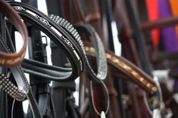 Fotobehang Paardrijden Close up of horse bridles in shop