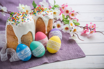 Easter Kulich cake with icing and colored eggs