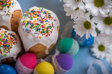 Easter Kulich cake with icing and colored eggs