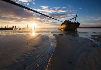 Fototapeta premium Old wrecked ship at sunrise in Kuala Penyu,Sabah,Borneo,Malaysia