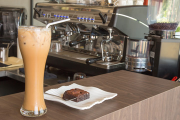 ice coffee and brownie on wood table in cafe