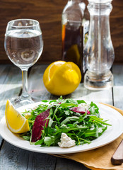 Fresh green salad with beets, goat cheese and olive oil