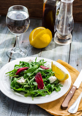 Fresh green salad with beets, goat cheese and olive oil