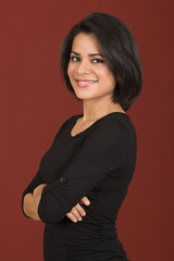 Beautiful latin woman smiling with her arms crossed