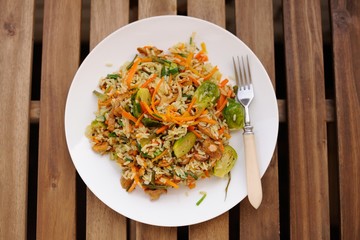 Fried rice with carrot and brussel sprouts in white plate