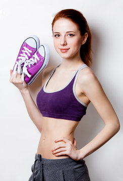 Woman showing her abs with gumshoes