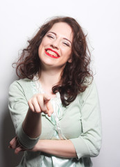 Beautiful young surprised curly woman.